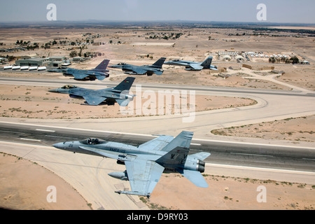 Jordanian and American F-16 Fighting Falcon fighter aircraft fly in formation with US Marine Corps F-18 fighters during training June 12, 2013 in Northern Jordan. Stock Photo