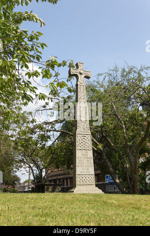 An ornate stone cross war memorial to the First world war dead of the Church of St. George on St. George's Road in Bolton.