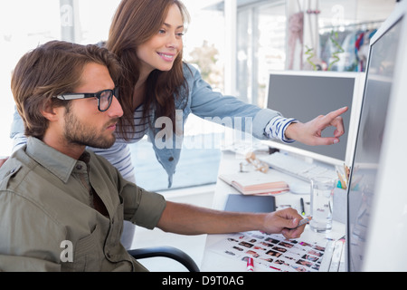 Colleague pointing photo out to editor Stock Photo