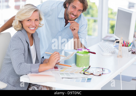 Smiling colleagues of interior design working together Stock Photo