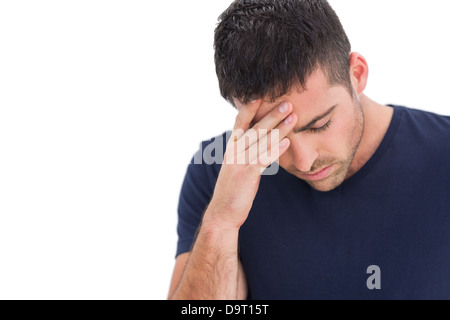 Upset man standing with his hand holding his forehead Stock Photo