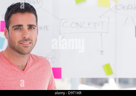 Designer standing in front of whiteboard Stock Photo