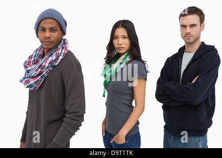 Stylish young people in a row looking serious Stock Photo