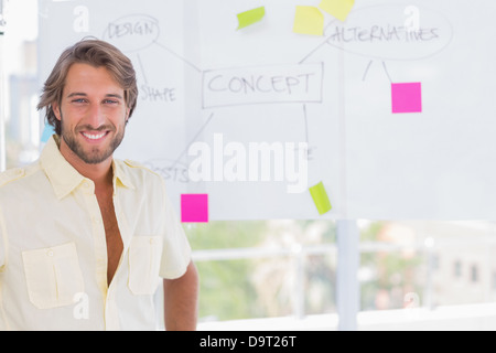 Handsome man standing in front of whiteboard Stock Photo