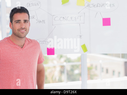 Happy man standing in front of whiteboard Stock Photo