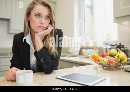 Thoughtful woman drinking coffee Stock Photo