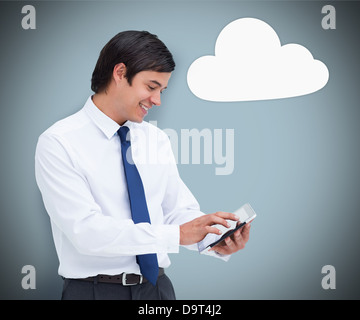 Businessman using a tablet pc with cloud computing symbol Stock Photo