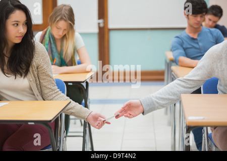 Two students cheating in the classroom Stock Photo