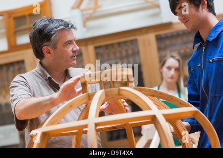 Explaining teacher in a woodwork class Stock Photo