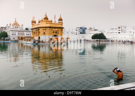 Bathing in the Pool of the Nectar of Immortality at the Golden Temple in Amritsar, India. Stock Photo