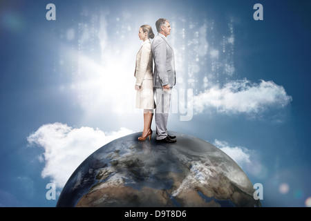 Business people on top of the world with computer matirx graphic Stock Photo