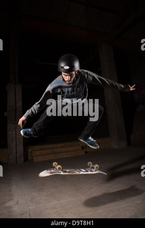 Skater doing kickflip trick Stock Photo