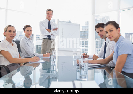 Serious business people looking at camera during a meeting Stock Photo