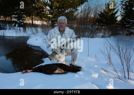 Man with harvested eastern wild Turkey in spring Stock Photo