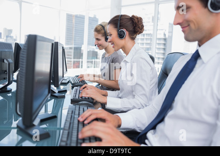 Group of call center agents working in line Stock Photo