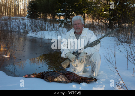 Man with harvested eastern wild Turkey in spring Stock Photo