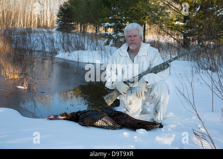 Man with harvested eastern wild Turkey in spring Stock Photo