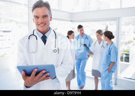 Smiling doctor holding digital tablet Stock Photo