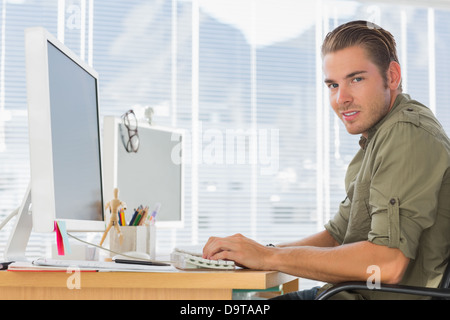 Smiling creative business employee working on computer Stock Photo