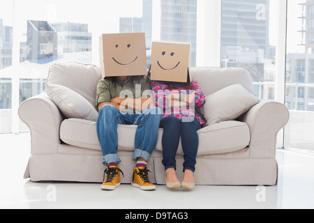 Silly workers wearing boxes on their heads Stock Photo