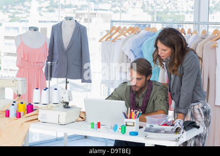 Two fashion designers working on laptop Stock Photo