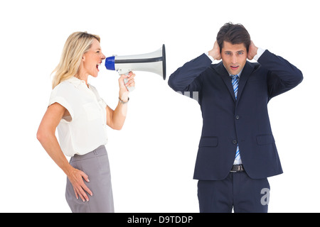 Businessman with hands on his ears because of megaphone Stock Photo