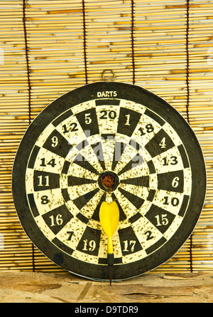 Old darts on a bamboo wall ready to use. Stock Photo