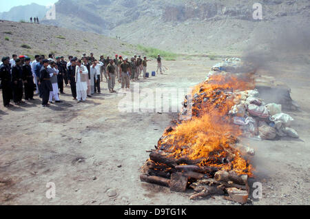 Bara, Pakistan. 26th June 2013. Anti-Narcotics Force (ANF) officials burn pile of confiscated drugs during ceremony on the occasion of International Day against Drug Abuse and Illicit Trafficking held in Bara on Wednesday, June 26, 2013. As the world observes International Day against Drug Abuse and Illicit Trafficking. Pakistan annually seizes huge quantities of drugs which straddle a route from neighboring Afghanistan, destined for lucrative markets in the Middle East. Credit:  Asianet-Pakistan/Alamy Live News Stock Photo