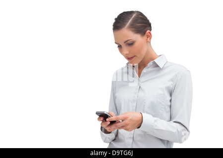 Businesswoman sending text message Stock Photo