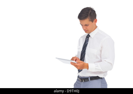 Frowning businessman using tablet Stock Photo