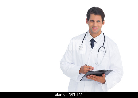 Smiling doctor holding a clipboard and pen Stock Photo