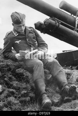 A soldiers reads a book in the trench during a lull in combat. Image is dated 21 October 1942. Place unknown. The image was taken by the German Wehrmacht in the context of the Nazi Propaganda! Fotoarchiv für Zeitgeschichte Stock Photo