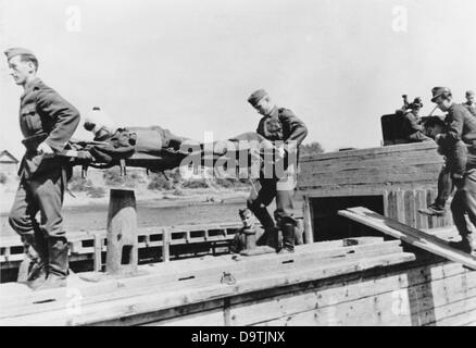 The Nazi Propaganda! on the back of the image reads: 'Runway No. 2: The river. Wounded soldiers and vacationers are brought Stock Photo