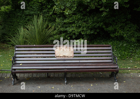 A bench bearing a plaque dedicated to survivors of the Magdalen laundries in St Stephen's Green, Dublin, Ireland, as a public memorial in the park. Stock Photo