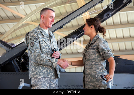 Major General Gary Cheek, deputy command general at Army Central Command (right) thanks Airman First Class Jami DeVries, from the 140th Wing, Colorado Air National Guard, for her explanation of F-16 maintenance during his visit to a training base in North Stock Photo