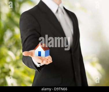 man hands holding eco house Stock Photo