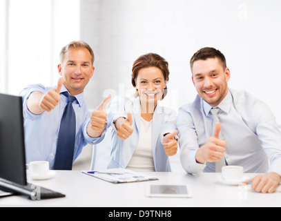 business team showing thumbs up in office Stock Photo