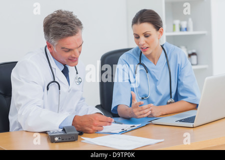 Two doctors working on an important folder Stock Photo