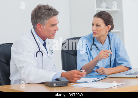 Two doctors discussing and working together Stock Photo