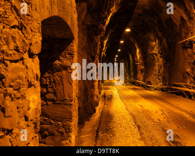 Rough hewn road under mountain - with car Stock Photo