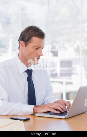Serious businessman working on laptop Stock Photo