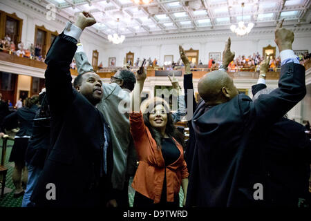 Texas Democratic lawmakers cheer along with supporters in the Senate chamber as a controversial abortion bill is defeated. Stock Photo