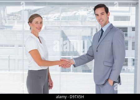 Two colleagues shaking hands Stock Photo