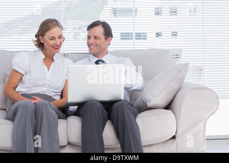 Two colleagues using laptop Stock Photo