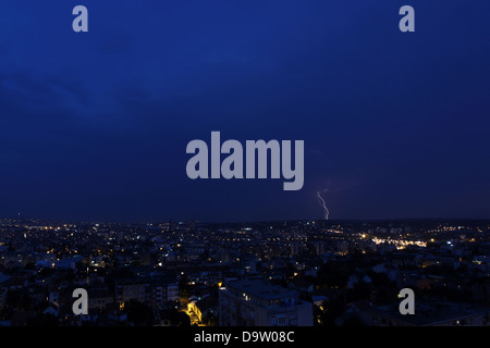 Multiple lightning strikes over a big city by night Stock Photo