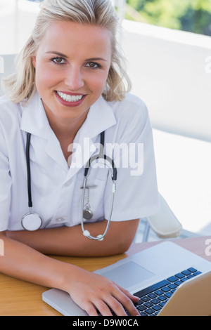 Portrait of a pretty nurse working on her laptop Stock Photo