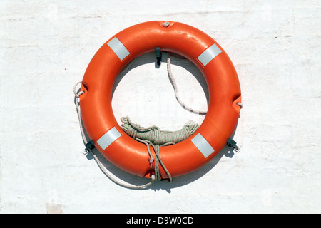 Red Life Buoy hanging on the wall Stock Photo
