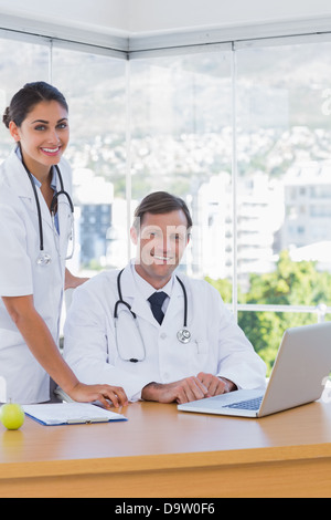 Cheerful doctors posing together in their office Stock Photo