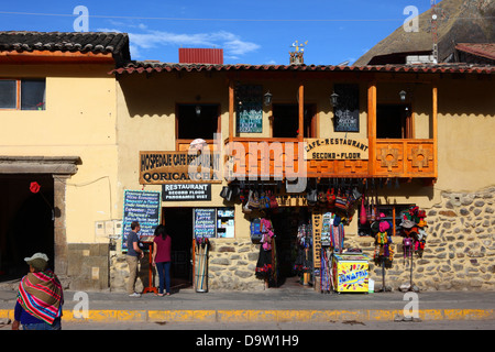 Tourists looking at menu on street outside cafe on Plaza de Armas, Ollantaytambo , Sacred Valley , near Cusco, Peru Stock Photo