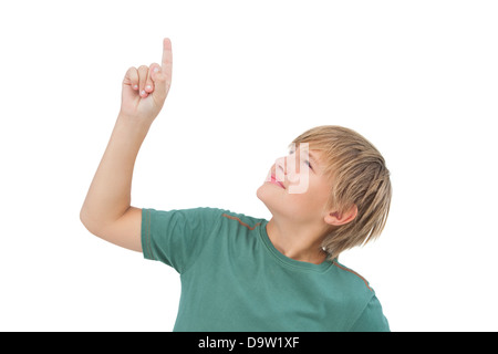 Boy raising his finger and looking up Stock Photo